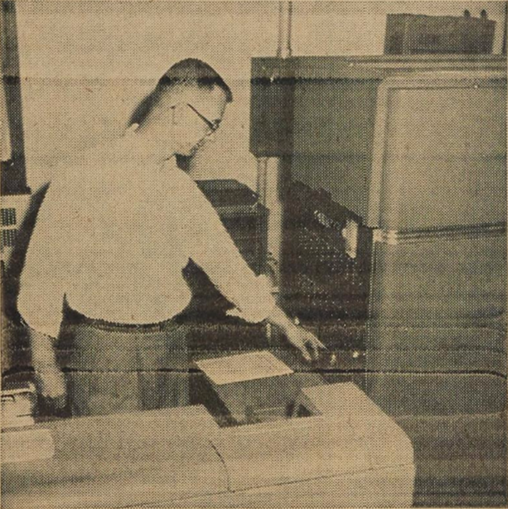 <p><font size="-2">Gerald C. Bailey stands before the giant mathematical brain of the new IBM 650 computer.</p>